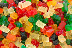 A bowl of gummy bears of different flavors